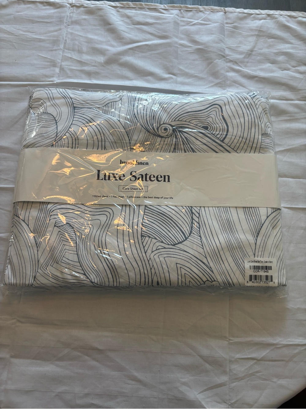 Brooklinen Luxe Sateen Core Sheet Set in White with Gray Line Pattern